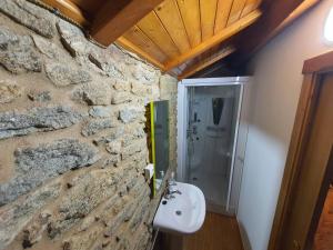 a stone bathroom with a sink and a shower at Casa do Campo in Viseo +13 photos