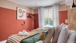 a childs room with a bed and a window at London Queen's Park with cinema & gaming room in London