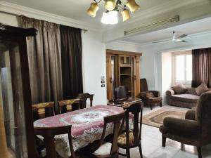 a living room with a table and a couch at شارع العريش هرم in Banī Ghālib
