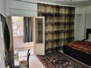 a bedroom with a bed and a door and a window at شارع العريش هرم in Banī Ghālib