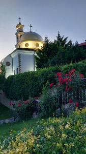 a church with a cross on top of a building at Ela, Kedar 5 in Sveti Vlas