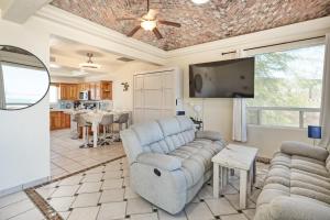 a living room with couches and a flat screen tv at 3 Story Home 3BR 2BA with Rooftop View and Heated Pool in La Choya