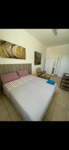 a bedroom with a large white bed in a room at San Pantaleone Appartamento Salento in Martignano