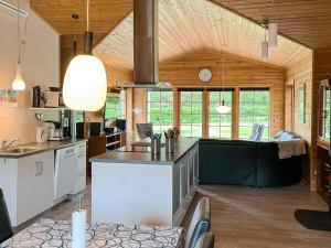 a large kitchen with a large island in a room at 8 person holiday home in Hadsund-By Traum in Odde
