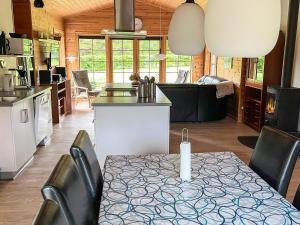 a kitchen and living room with a table and chairs at 8 person holiday home in Hadsund-By Traum in Odde +24 photos