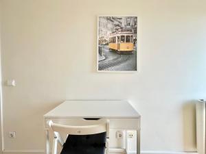 a white table with a picture of a tram at Deluxe Oceanfront - Vue Sur la Mer in Peniche