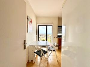 a dining room with a table and two chairs at Deluxe Oceanfront - Vue Sur la Mer in Peniche