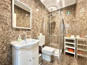 a bathroom with a sink and a toilet and a shower at Deluxe Oceanfront - Vue Sur la Mer in Peniche +36 photos