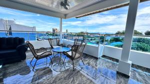 a balcony with a table and chairs and a view at Hotel Costa Norte in Necoclí