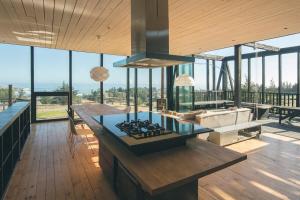 a kitchen with a stove top oven in a house at Punta de Lobos Black House in Pichilemu