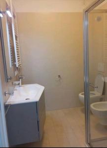 a bathroom with a sink and a toilet and a shower at Appartamento Azzurro in Roseto degli Abruzzi +11 photos