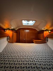 an empty room with a bed and a skylight at Voilier Dufour Classic 35 in Hendaye +7 photos