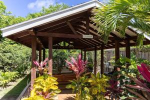 a wooden pergola in a garden with plants at Island Gardens Family Escape, Pool & Car included in Nassau