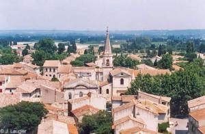 a view of a village with a church in the distance at La Maison Des Bouissonne in Maillane