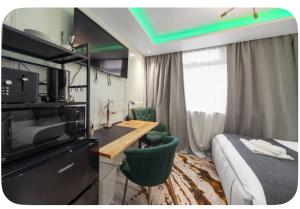 a hotel room with a bed and a desk in a room at South East Ensuite 12mins to Elizabeth line in Thamesmead
