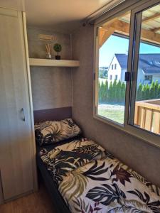 a small room with two beds in it with a window at Mobilní dům Krajánek in Výrovice