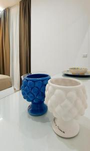 two blue and white vases sitting on a table at Villa Anna al Duomo in Taormina