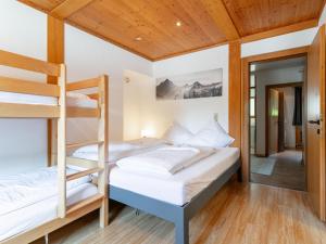 a bedroom with two bunk beds and a hallway at Gaisberg Alpin in Kirchberg in Tirol