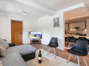 a living room with a couch and chairs and a kitchen at Gaisberg Alpin in Kirchberg in Tirol
