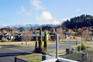 a view of a street in a town with mountains at Luxury on Rutherford in Hanmer Springs