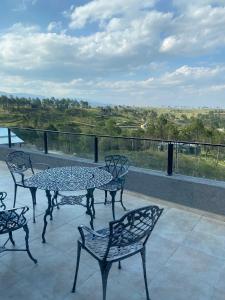 Una mesa y sillas en un balcón con vista. en Casal Sur, en Potrero de Garay