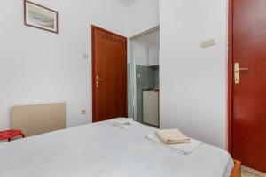 a bedroom with a white bed and a mirror at Studio Podaca 516a in Podaca