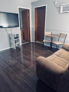 a living room with a couch and a table at Sunset Motel in Radium Hot Springs +41 photos