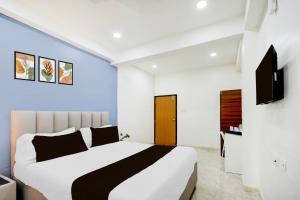 a bedroom with a large bed and a tv at Townhouse Nagole Metro Station Formerly Saka Arcade in Upal