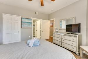 a bedroom with a bed and a flat screen tv at Saltwater Pool and 4 Mi to Beach Clearwater Condo! in Clearwater +19 photos