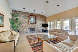 a living room with two couches and a fireplace at Saltwater Pool and 4 Mi to Beach Clearwater Condo! in Clearwater