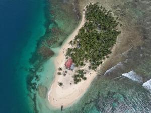 an island with a house on an island in the ocean at Camping Tent on Guna Yala Island in Panama City