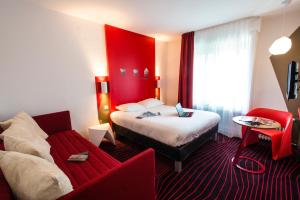 um quarto de hotel com uma cama e um sofá em Ibis Styles Rouen Centre Cathédrale em Rouen