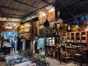 a restaurant with a bar with tables and chairs at ŞİRİNCEM PLUs 