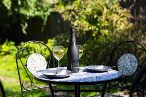 a bottle of wine sitting on a table with two glasses at Durham Hideaway in Gilesgate