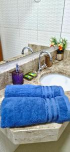 a blue towel sitting on a bathroom sink at Praieira Pousada in Itacaré +37 photos