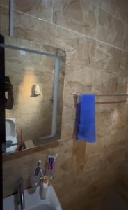 a bathroom with a sink and a mirror and a toilet at Realms apartment in Abuja