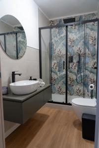 a bathroom with a sink and a shower at Amuri Holiday Home in Agrigento
