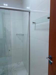a shower with a glass door in a bathroom at Apartamento mobiliado Ananindeua in Benjamim +6 photos