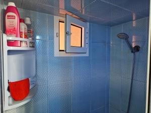 a bathroom with a shower with blue tiled walls at Casa Pearl in Chefchaouene +41 photos