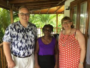 a man and two women standing next to each other at The Pool House in Saint Philip