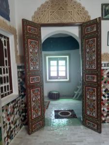 an entrance to a room with a window and a tile floor at Riad Serendipity in Fès +121 photos