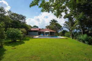 a house with a swimming pool in a yard at Chácara Vista Bela in Pinhalzinho
