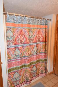 a shower curtain with an oriental pattern on it at Laurel Lake Cabins in Corbin +176 photos