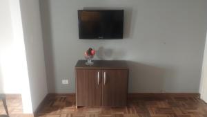 a room with a cabinet with a tv on a wall at IDEA Hotel Confort in Piracicaba
