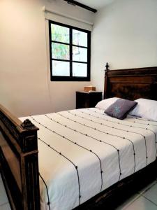 a bedroom with a large bed with a window at Casa Bugambilia Villa with Private Pool and Parking Merida in Mérida