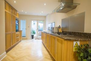 a kitchen with wooden cabinets and a counter top at Chester Apartments in Chester