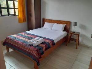 BUNGAVILLA House Tarapoto في تارابوتو: غرفة نوم بها سرير عليه منشفتان