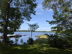 a boat is docked at a dock on a lake at Bungalow on Lake Charles Halifax-Dartmouth HRM in Bills Island