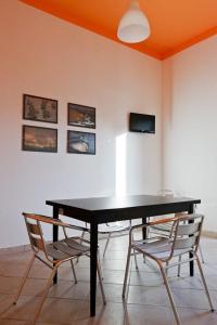 a black table and two chairs in a room at Casa Letizia in Porto Cesareo +14 photos