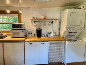 a kitchen with white appliances on a wooden counter at Chill Cottage in Punta Gorda in Punta Gorda
